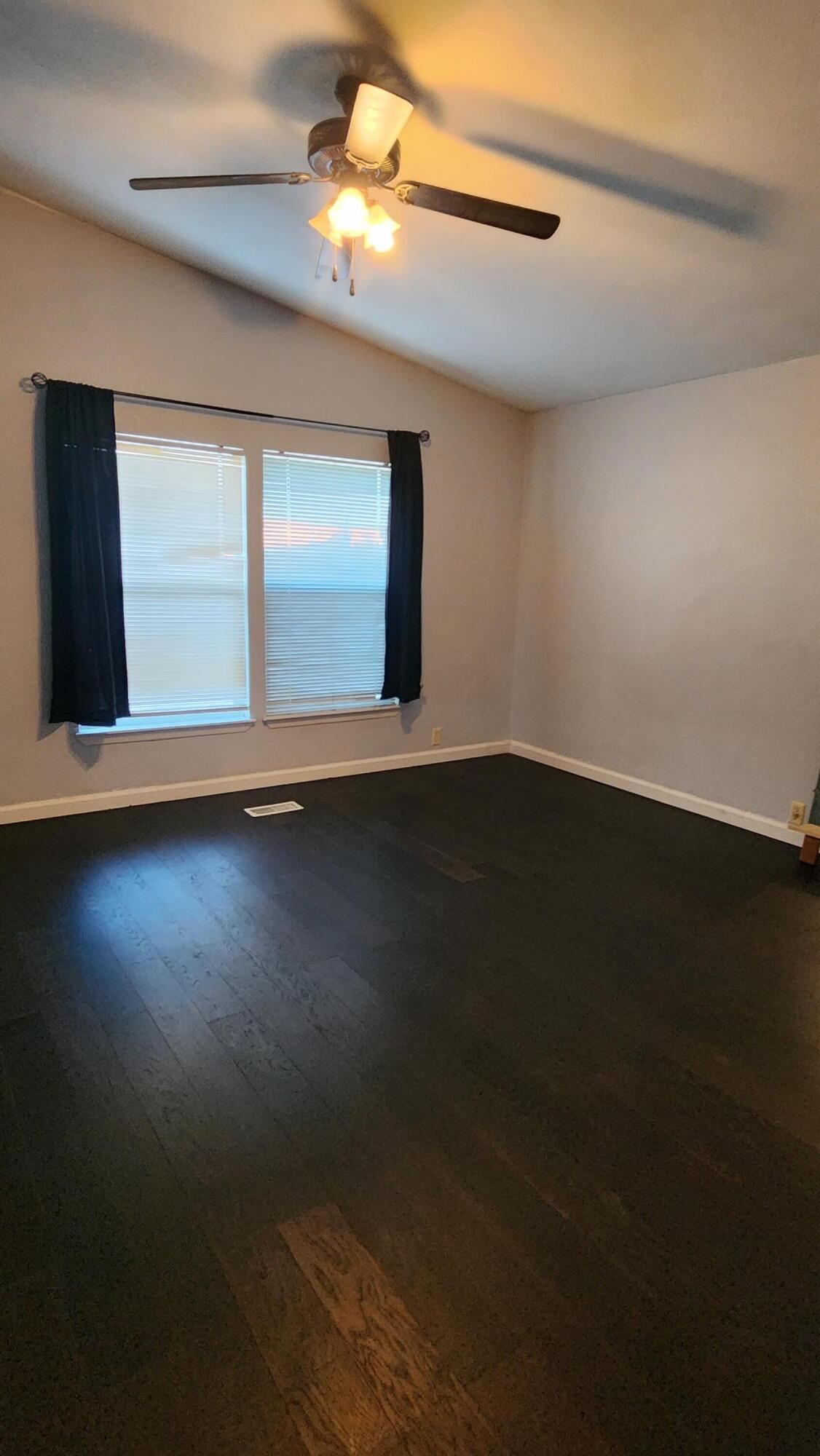 3641 Dawn Road Rosamond, CA 93560 - Photo 15 of 33 a view of an empty room with wooden floor and a window