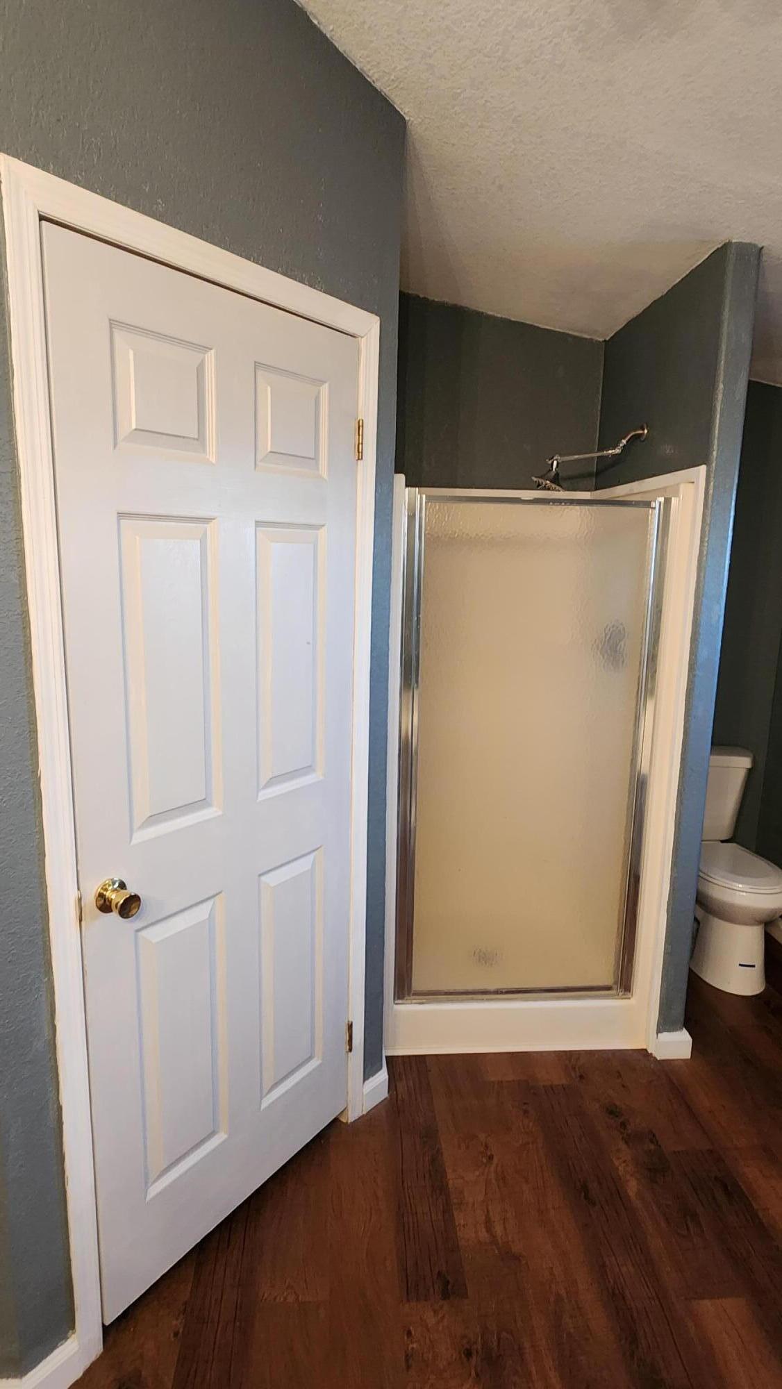 3641 Dawn Road Rosamond, CA 93560 - Photo 17 of 33 an empty room with wooden floor and cabinet