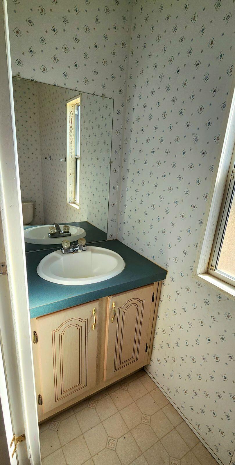 3641 Dawn Road Rosamond, CA 93560 - Photo 29 of 33 a bathroom with a sink a toilet and a mirror