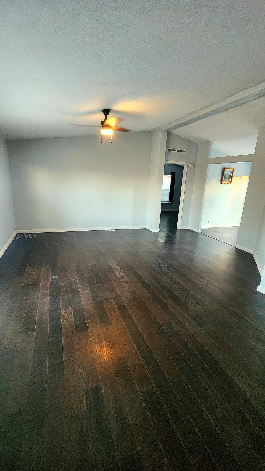3641 Dawn Road Rosamond, CA 93560 - Photo 3 of 33 an empty room with wooden floor and windows