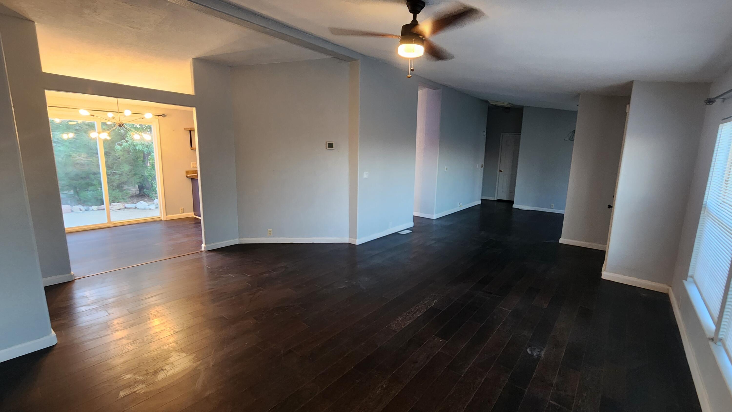 3641 Dawn Road Rosamond, CA 93560 - Photo 5 of 33 a view of an empty room with wooden floor and a window