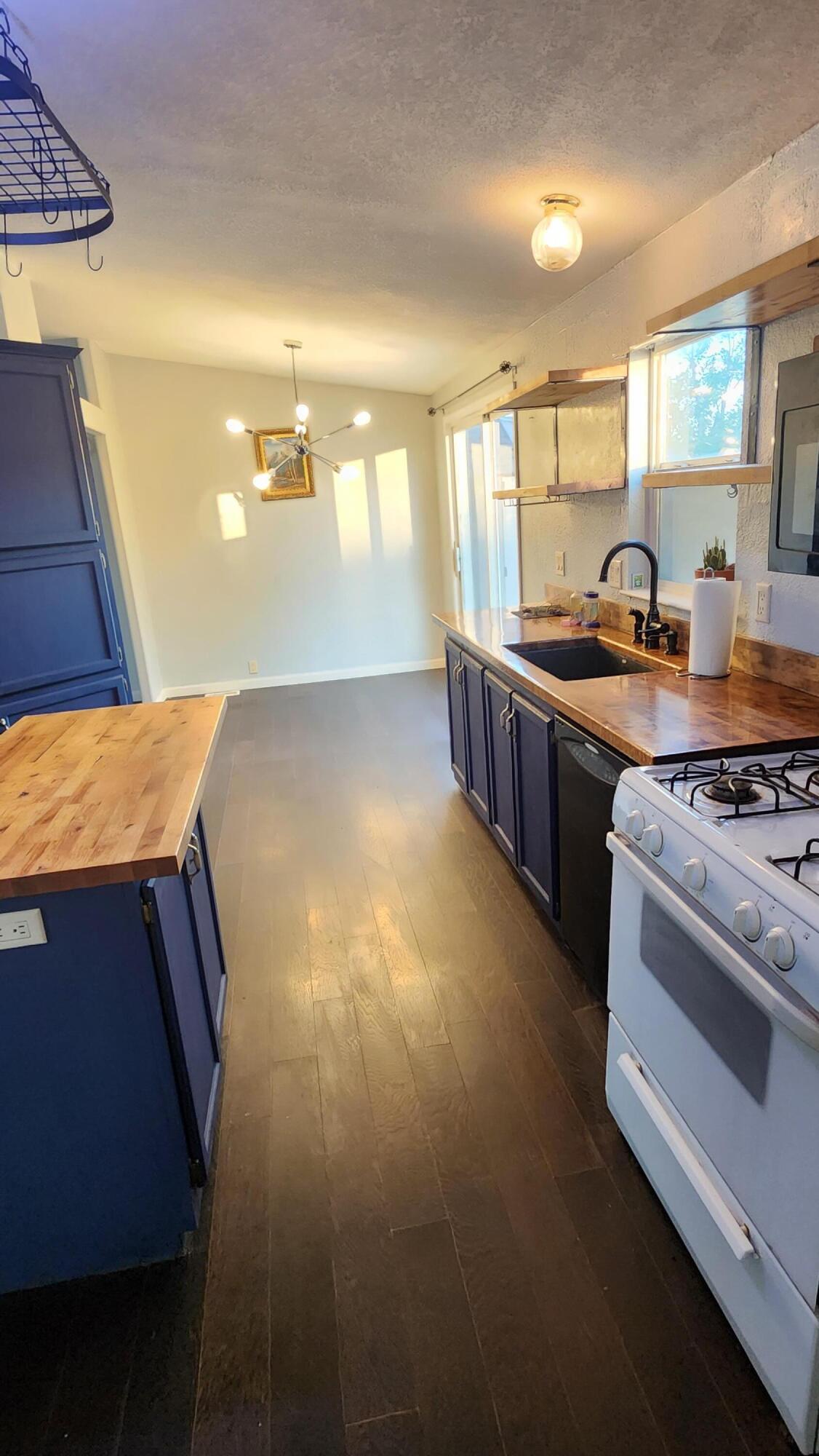 3641 Dawn Road Rosamond, CA 93560 - Photo 8 of 33 a kitchen with stainless steel appliances granite countertop a stove a sink and a refrigerator