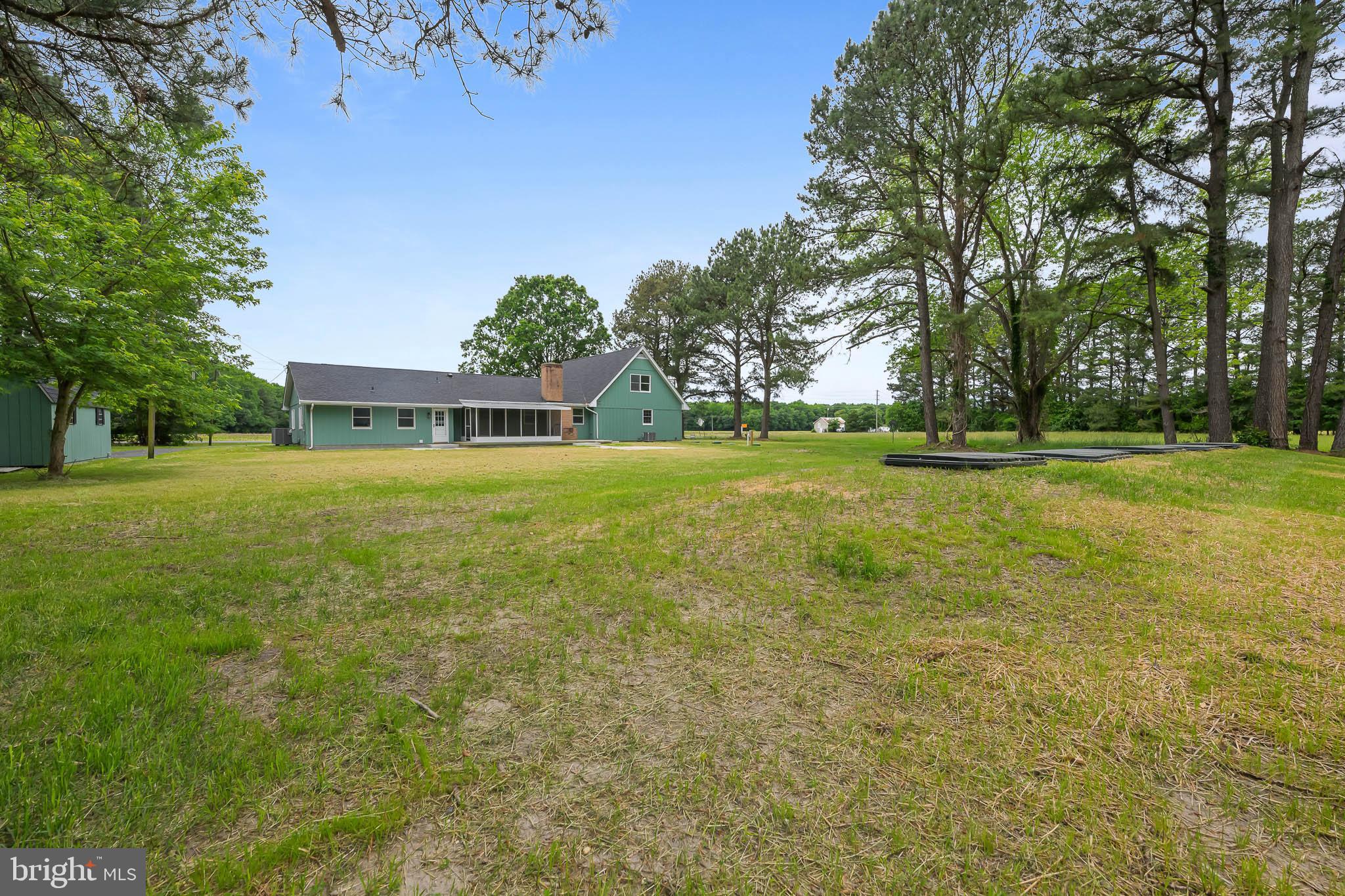 21830 Vaughn Road Georgetown, DE 19947 - Photo 37 of 39 a view of a big yard with trees in the background