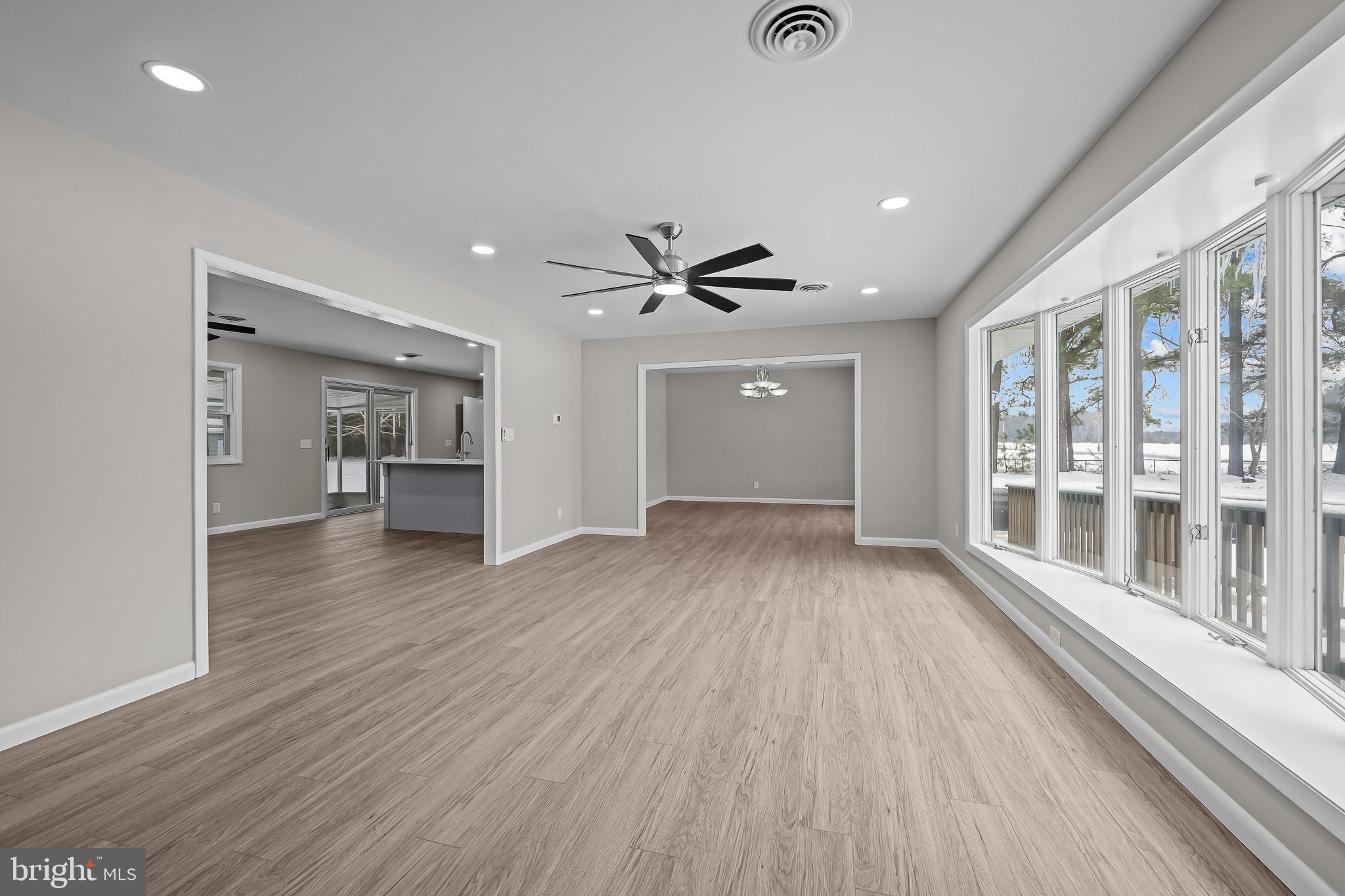 21830 Vaughn Road Georgetown, DE 19947 - Photo 6 of 39 wooden floor in an empty room with a window