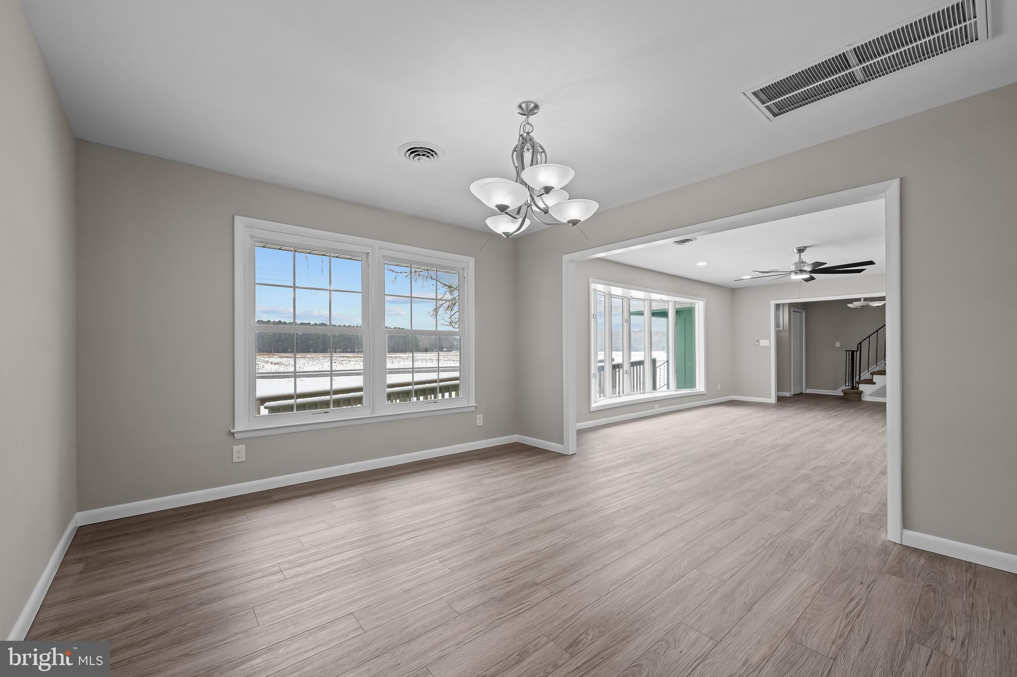 21830 Vaughn Road Georgetown, DE 19947 - Photo 8 of 39 a view of an empty room with wooden floor and a window