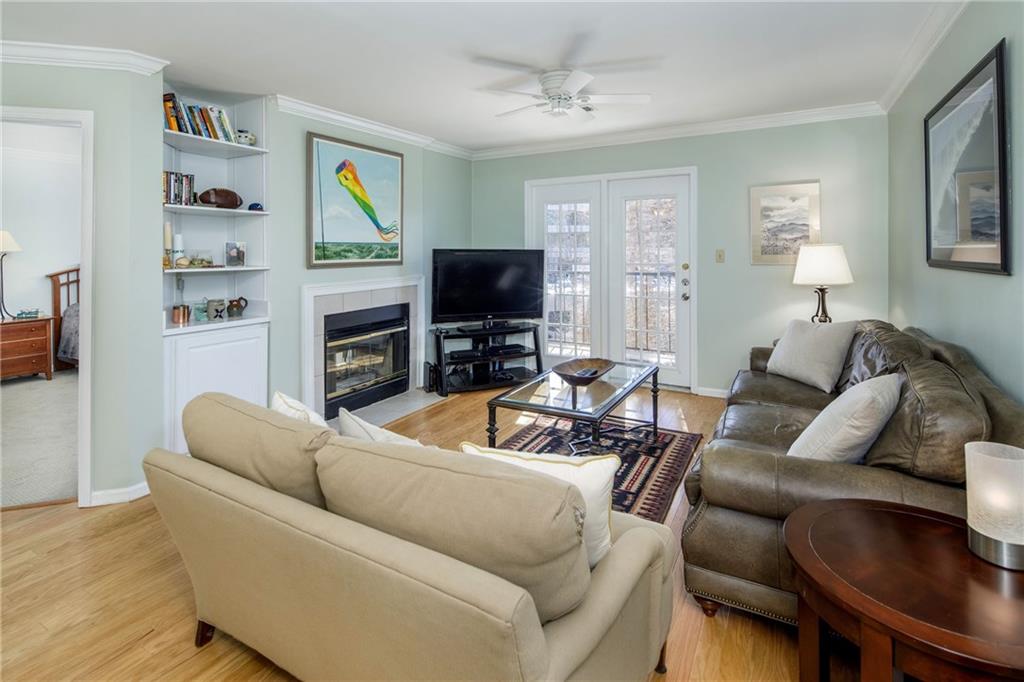 3655 Habersham Road Northeast, Unit B352 Atlanta, GA 30305 - Photo 1 of 1 a living room with furniture a flat screen tv and a fireplace