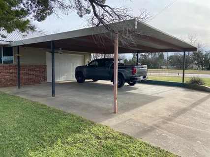 a kitchen with a sink cabinets and wooden floor