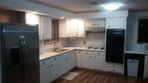 a view of a bathroom with a sink and a mirror