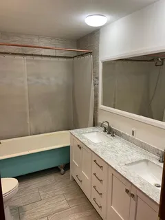 a room with a flat screen tv and a sink