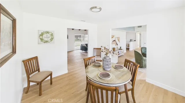 a dining room with furniture and wooden floor