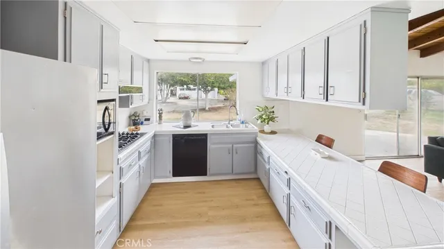 a kitchen with a sink stove and cabinets
