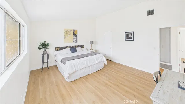 a bedroom with a bed and a large mirror