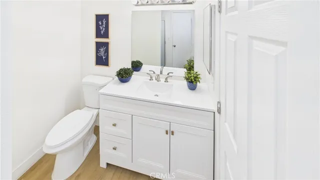 a bathroom with a sink vanity mirror and toilet