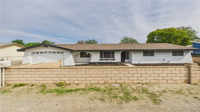 a front view of a house with a wooden fence