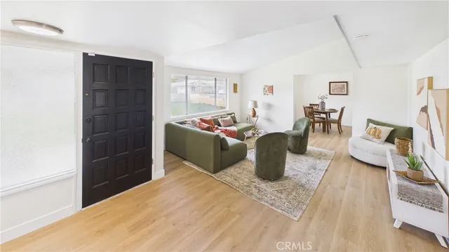 a living room with furniture a rug and a window