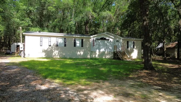 a front view of house with yard and green space