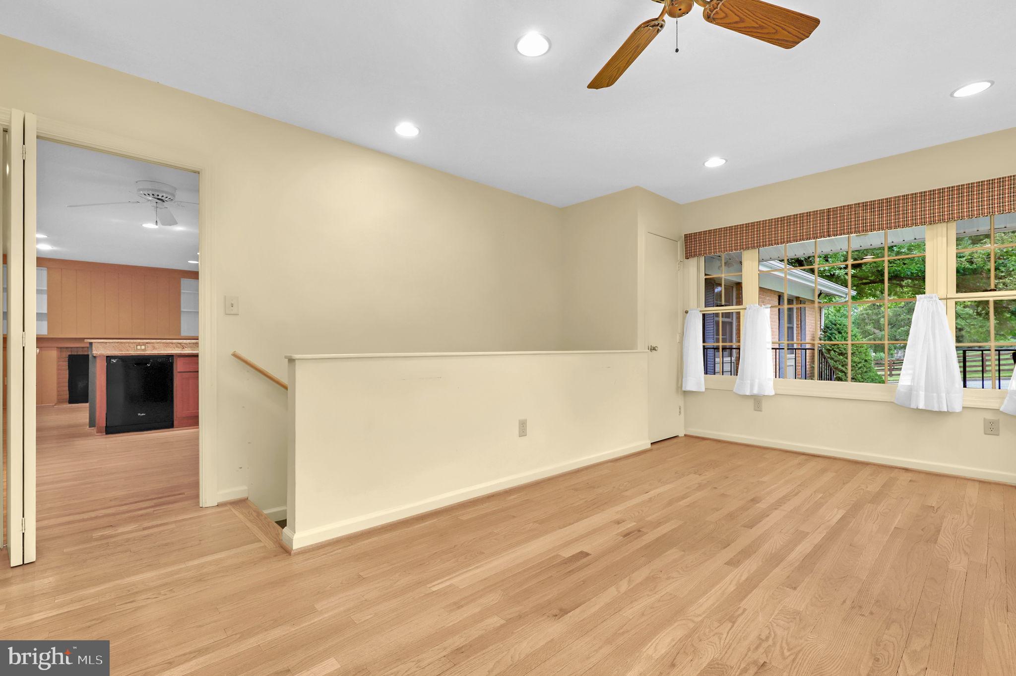 110 Linden Boulevard Middletown, MD 21769 - Photo 14 of 38 an empty room with wooden floor and windows