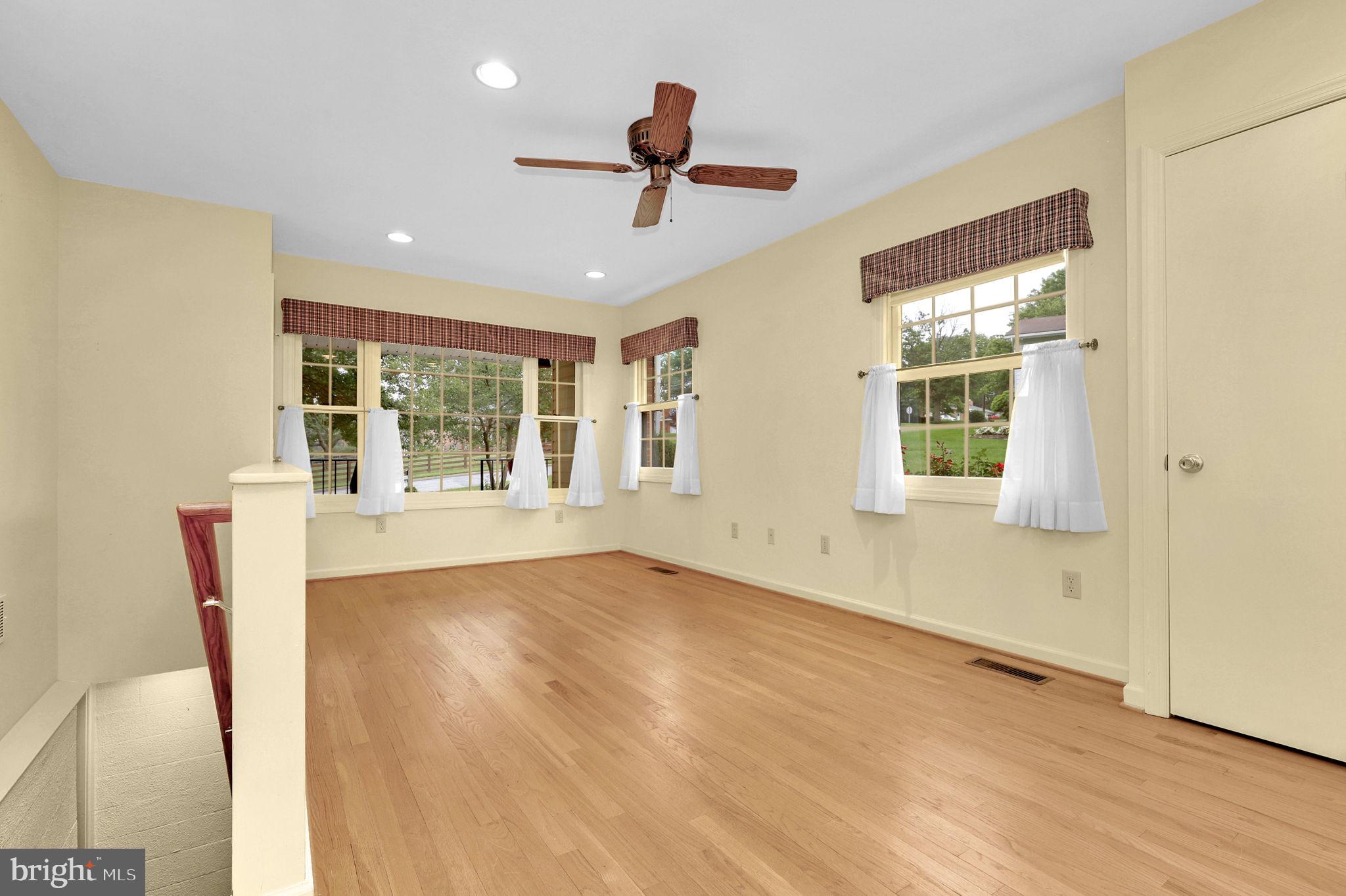 110 Linden Boulevard Middletown, MD 21769 - Photo 15 of 38 a view of an empty room with wooden floor and a window