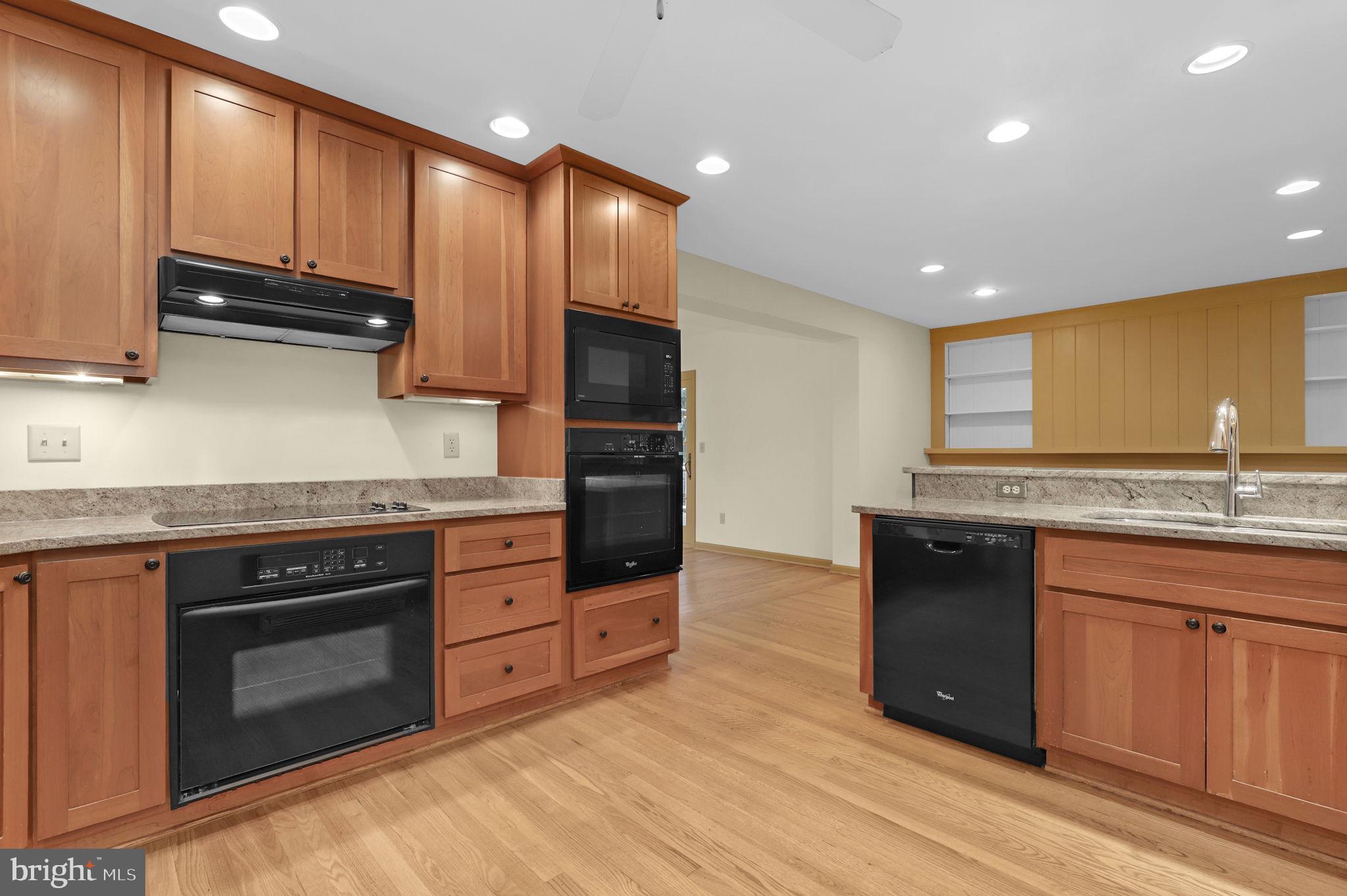 110 Linden Boulevard Middletown, MD 21769 - Photo 4 of 38 a kitchen with stainless steel appliances granite countertop a stove a sink and a microwave