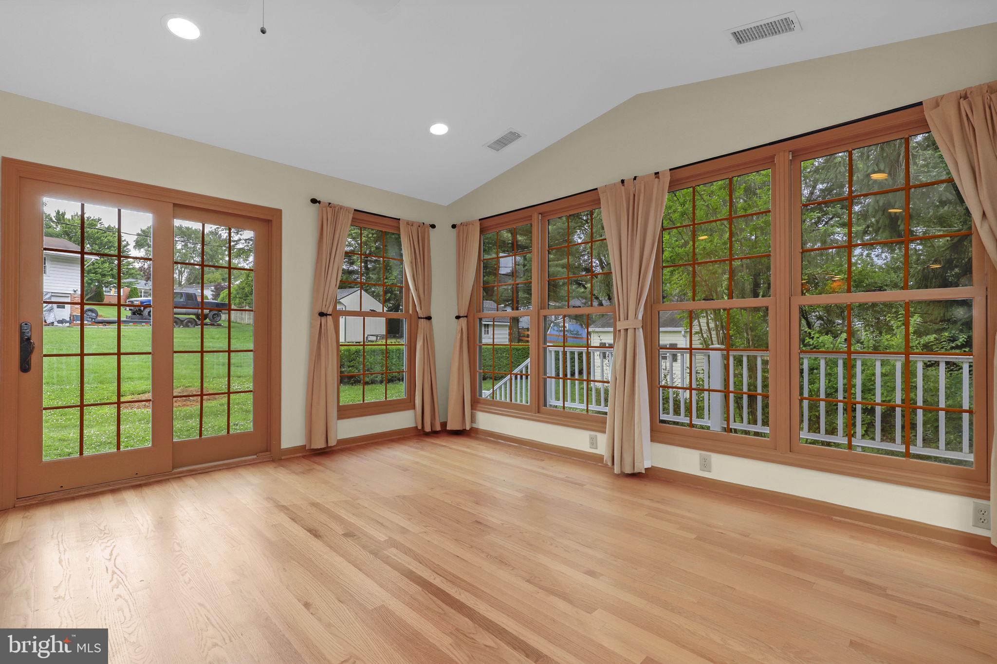 110 Linden Boulevard Middletown, MD 21769 - Photo 9 of 38 a view of an empty room with wooden floor and floor to ceiling window