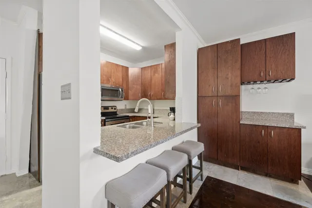 a kitchen with stainless steel appliances granite countertop a refrigerator sink and cabinets