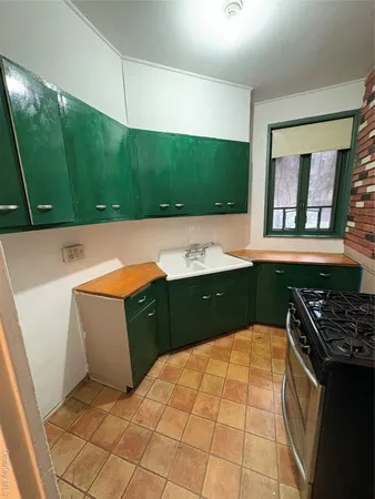 a kitchen with a cabinets a sink and a stove top oven