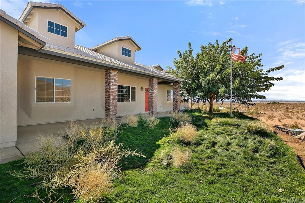 25025 Little Teepee Road Apple Valley, CA 92307 - Photo 1 of 1 a front view of a house with garden