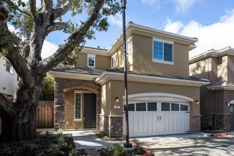 front view of a house with a tree