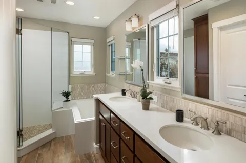 a bathroom with double vanity sink and a mirror