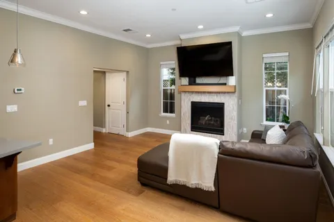 a living room with furniture a fireplace and a flat screen tv