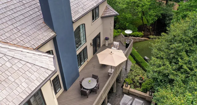 a backyard of a house with wooden floor and fence