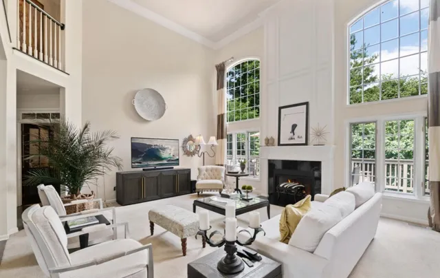 a living room with furniture a fireplace and window