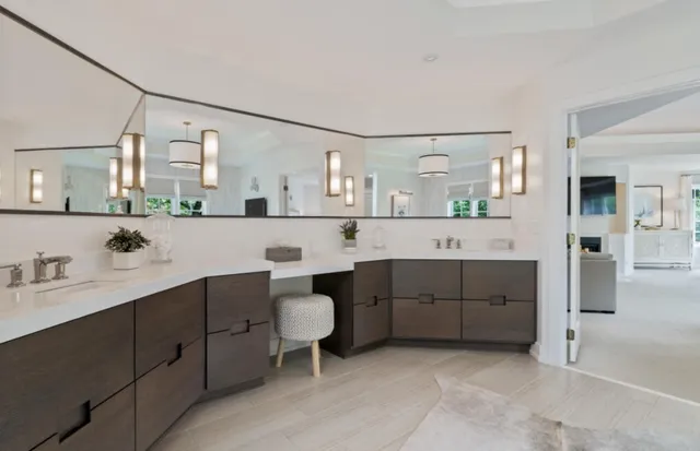 a large bathroom with a double vanity sink a mirror and a bathtub