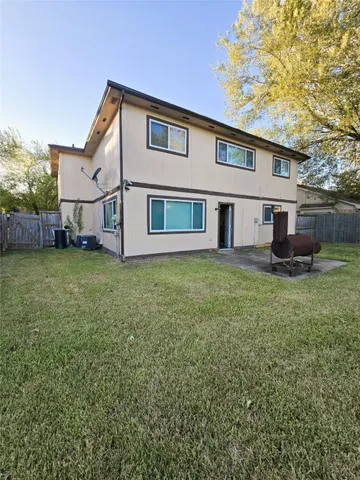 a front view of a house with a garden and yard
