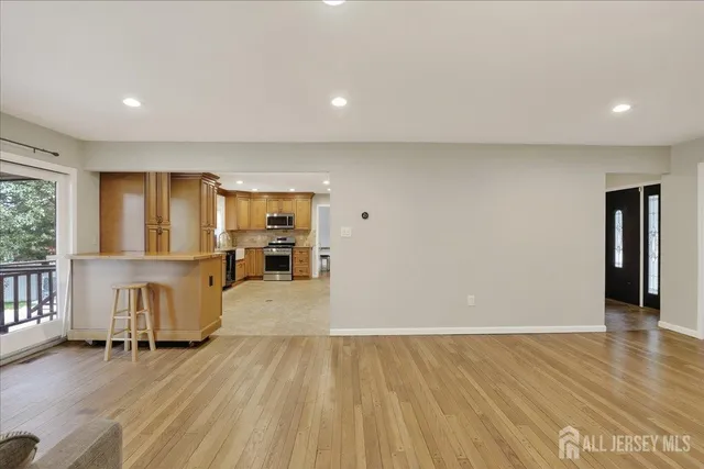 a kitchen with stainless steel appliances granite countertop a stove a sink and a refrigerator