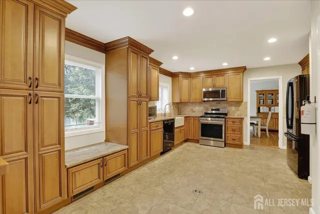 a bathroom with a granite countertop sink a toilet and shower