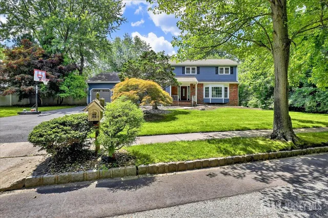 a bathroom with a granite countertop toilet sink and mirror