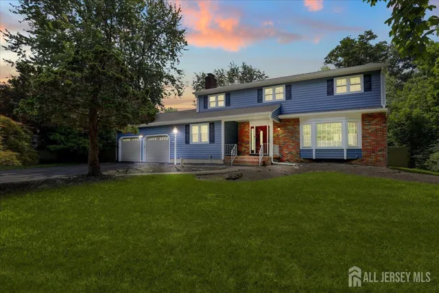 a front view of a house with a garden