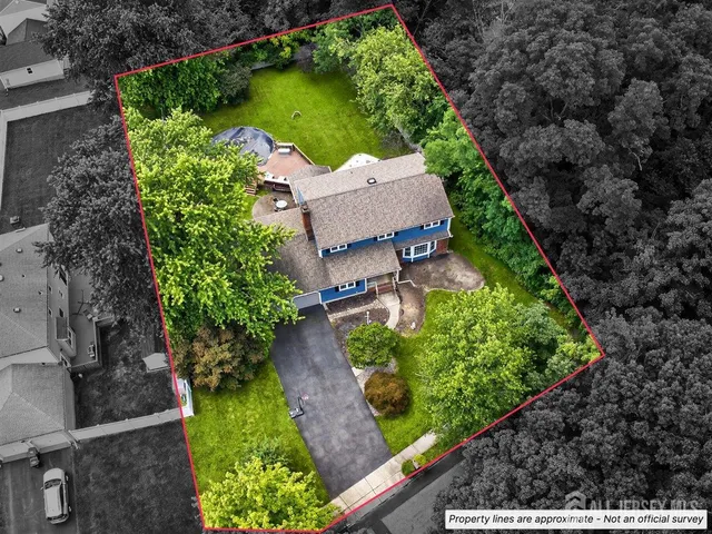 a front view of a house with a garden and trees