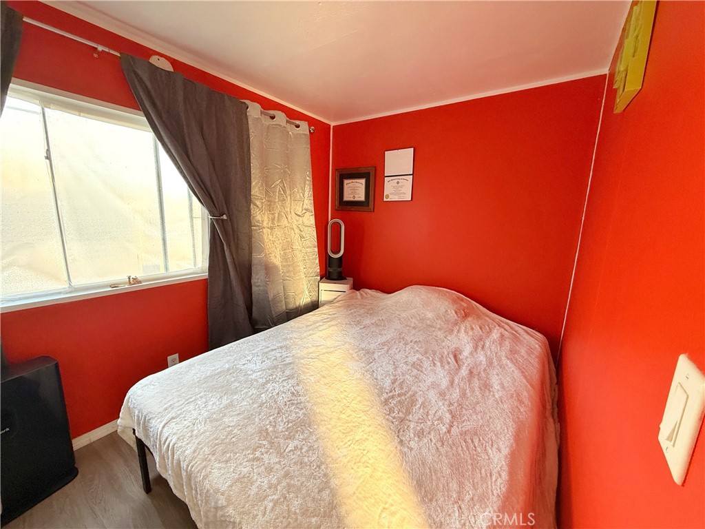 14925 Great Overland Stage Route, Unit A13 Julian, CA 92036 - Photo 11 of 19 a bedroom with a bed and wooden floor