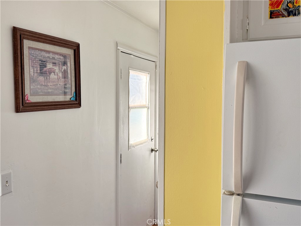 14925 Great Overland Stage Route, Unit A13 Julian, CA 92036 - Photo 14 of 19 a view of a hallway with a refrigerator