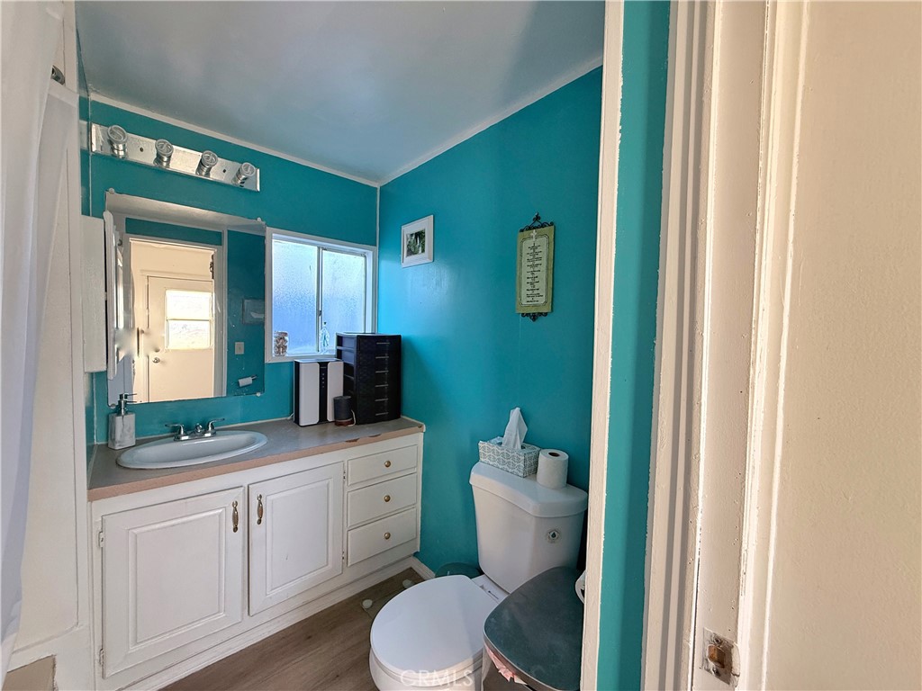 14925 Great Overland Stage Route, Unit A13 Julian, CA 92036 - Photo 15 of 19 a bathroom with a toilet a sink and mirror