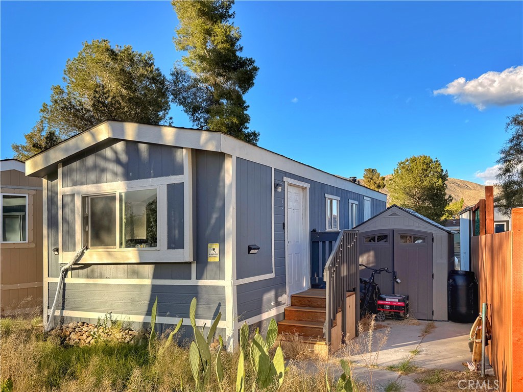 14925 Great Overland Stage Route, Unit A13 Julian, CA 92036 - Photo 2 of 19 a view of a house with backyard porch and furniture