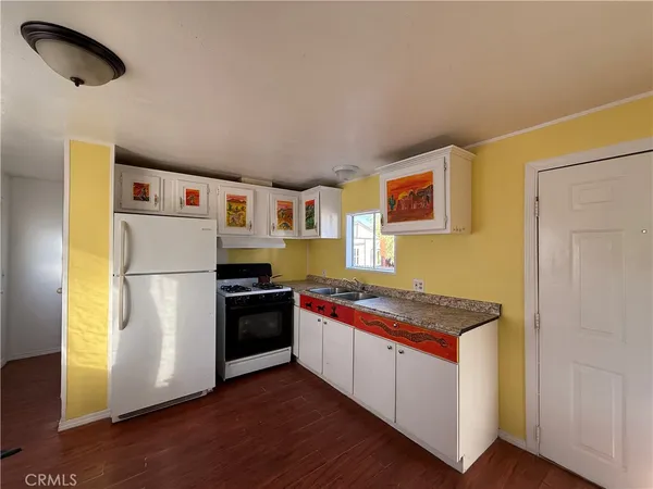 a kitchen with stainless steel appliances granite countertop a refrigerator and a stove