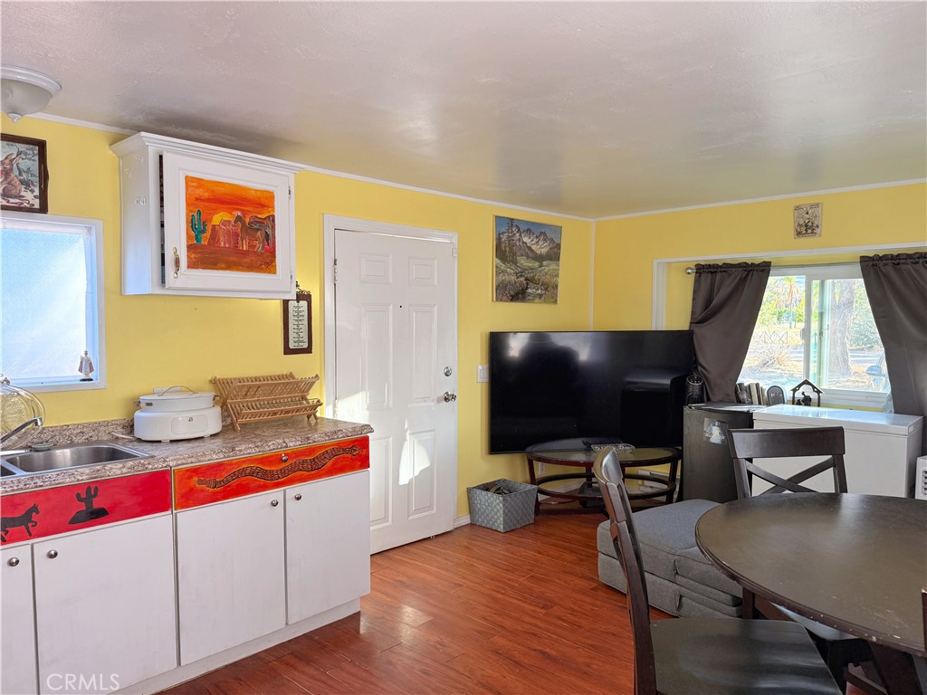 14925 Great Overland Stage Route, Unit A13 Julian, CA 92036 - Photo 5 of 19 a living room with furniture and a flat screen tv
