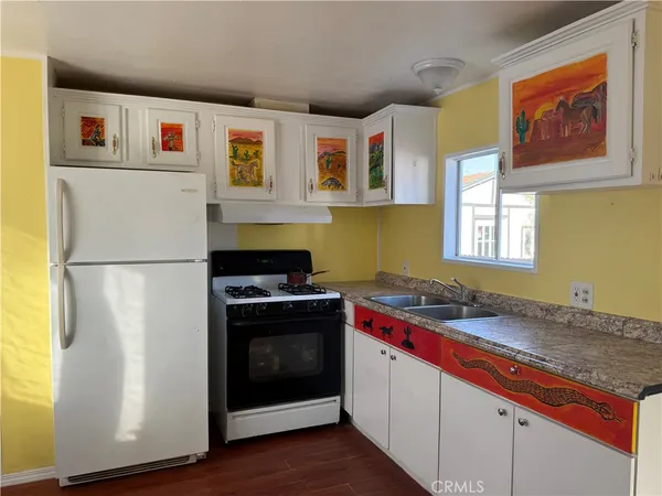 a kitchen with stainless steel appliances granite countertop a stove and a refrigerator