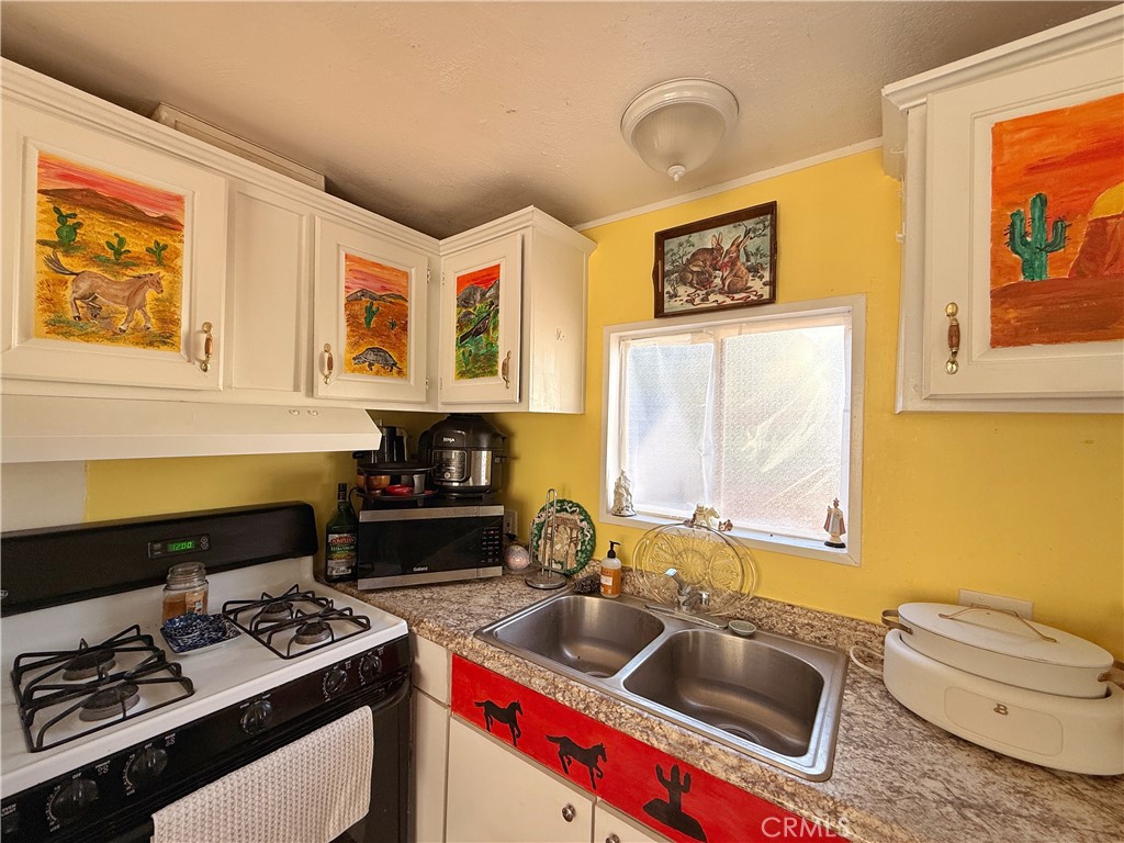 14925 Great Overland Stage Route, Unit A13 Julian, CA 92036 - Photo 7 of 19 a kitchen that has a sink and a stove