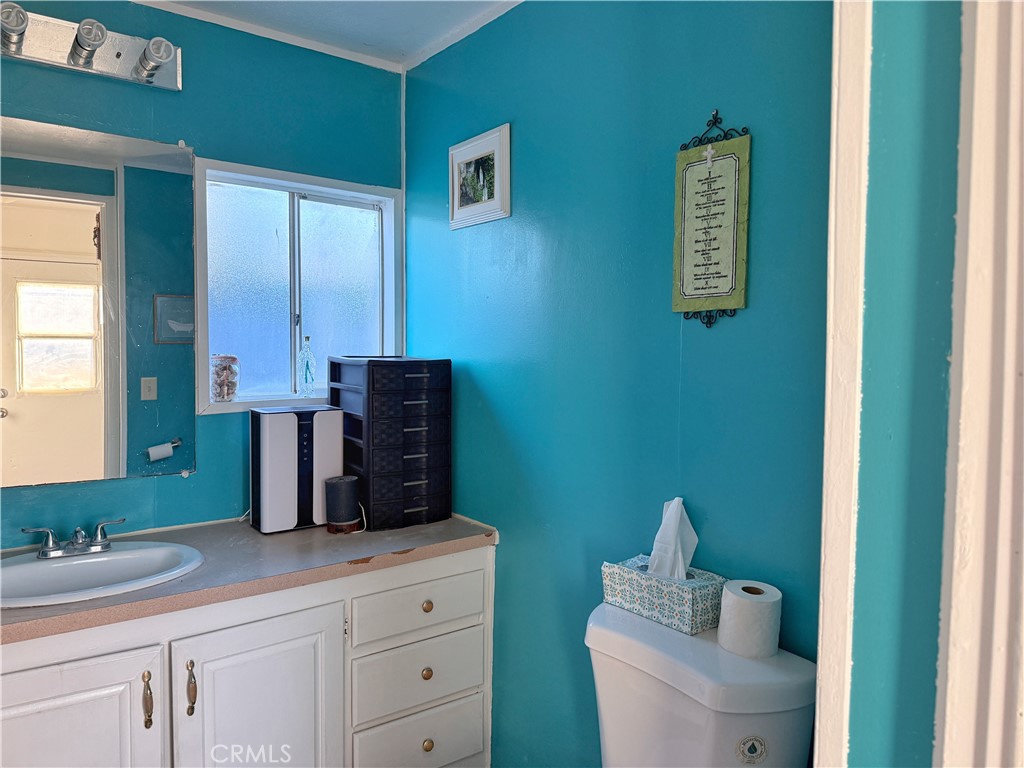 14925 Great Overland Stage Route, Unit A13 Julian, CA 92036 - Photo 8 of 19 a bathroom with a toilet sink and mirror
