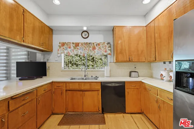 a kitchen with stainless steel appliances a stove sink microwave and cabinets