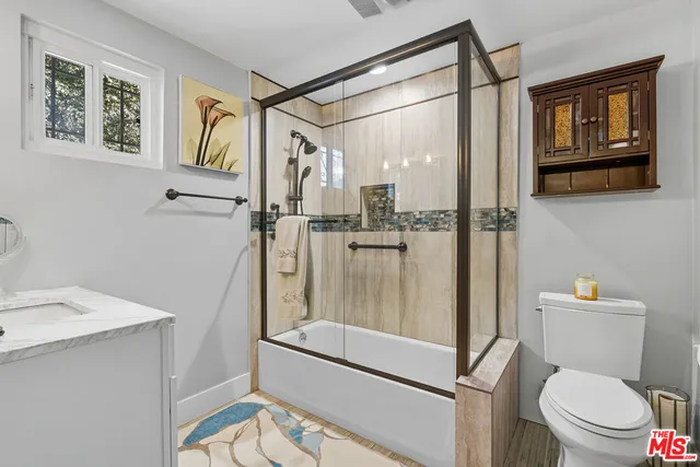 a bathroom with a shower a toilet and a sink